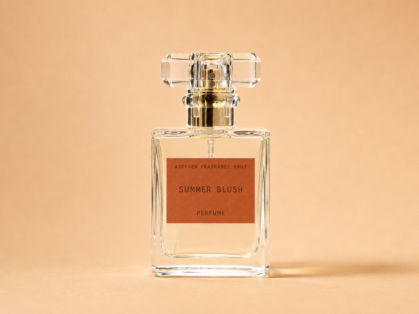 Summer Blush perfume by Astraea Fragrance Haus displayed in a sleek bottle with a soft pink hue.