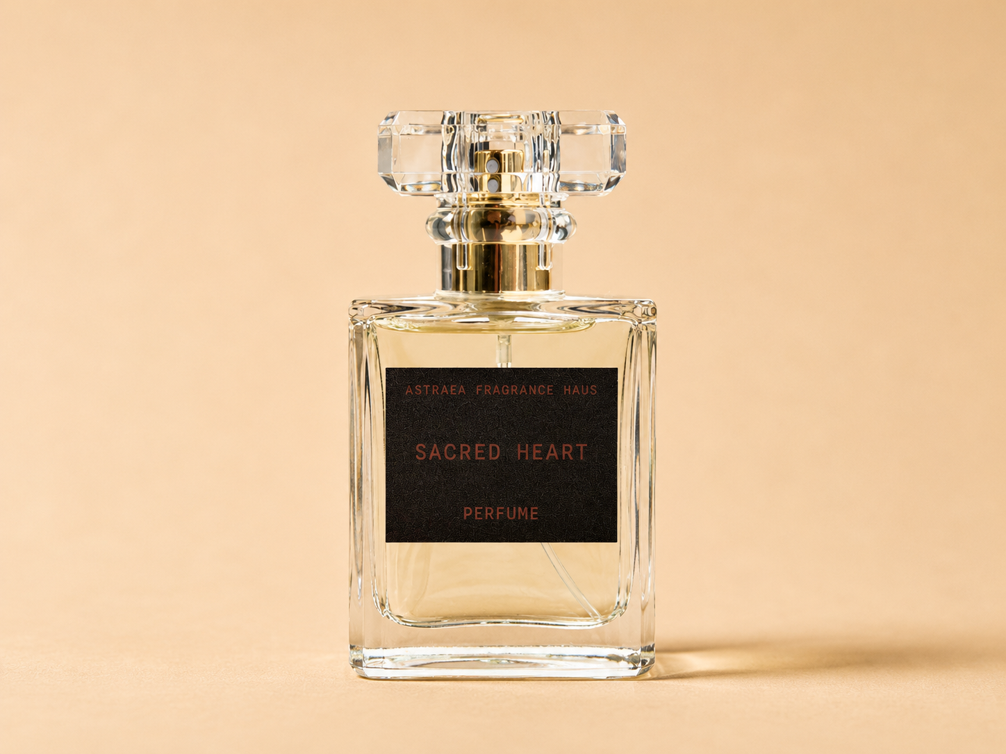 Sacred Heart perfume by Astraea Fragrance Haus, elegant glass bottle with floral and spicy fragrance notes, displayed on a white background.
