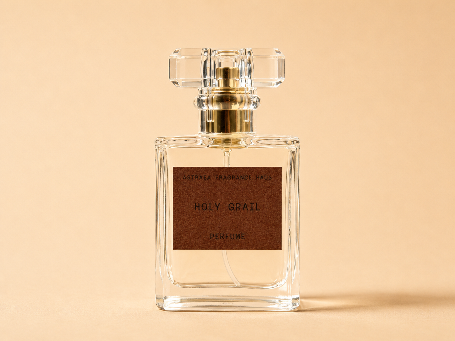 Aqua blue bottle of Holy Grail perfume by Astraea Fragrance Haus with elegant label design on a white background.