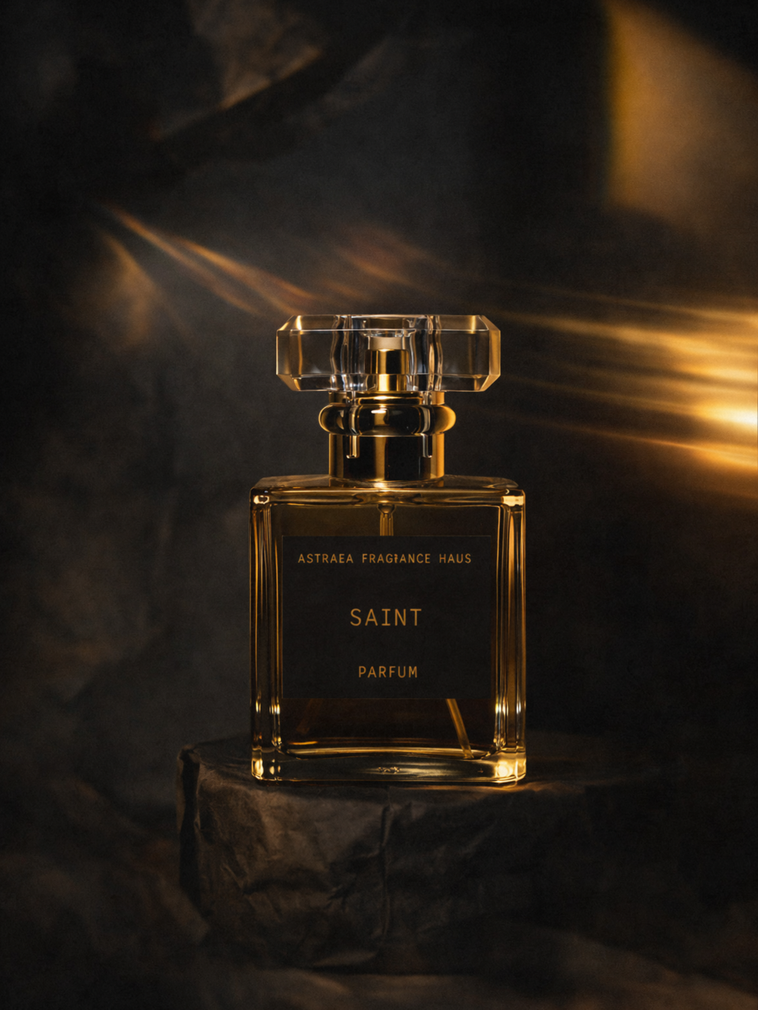 Saint perfume bottle by Astraea Fragrance Haus, elegant glass container with a sleek design and a decorative cap.