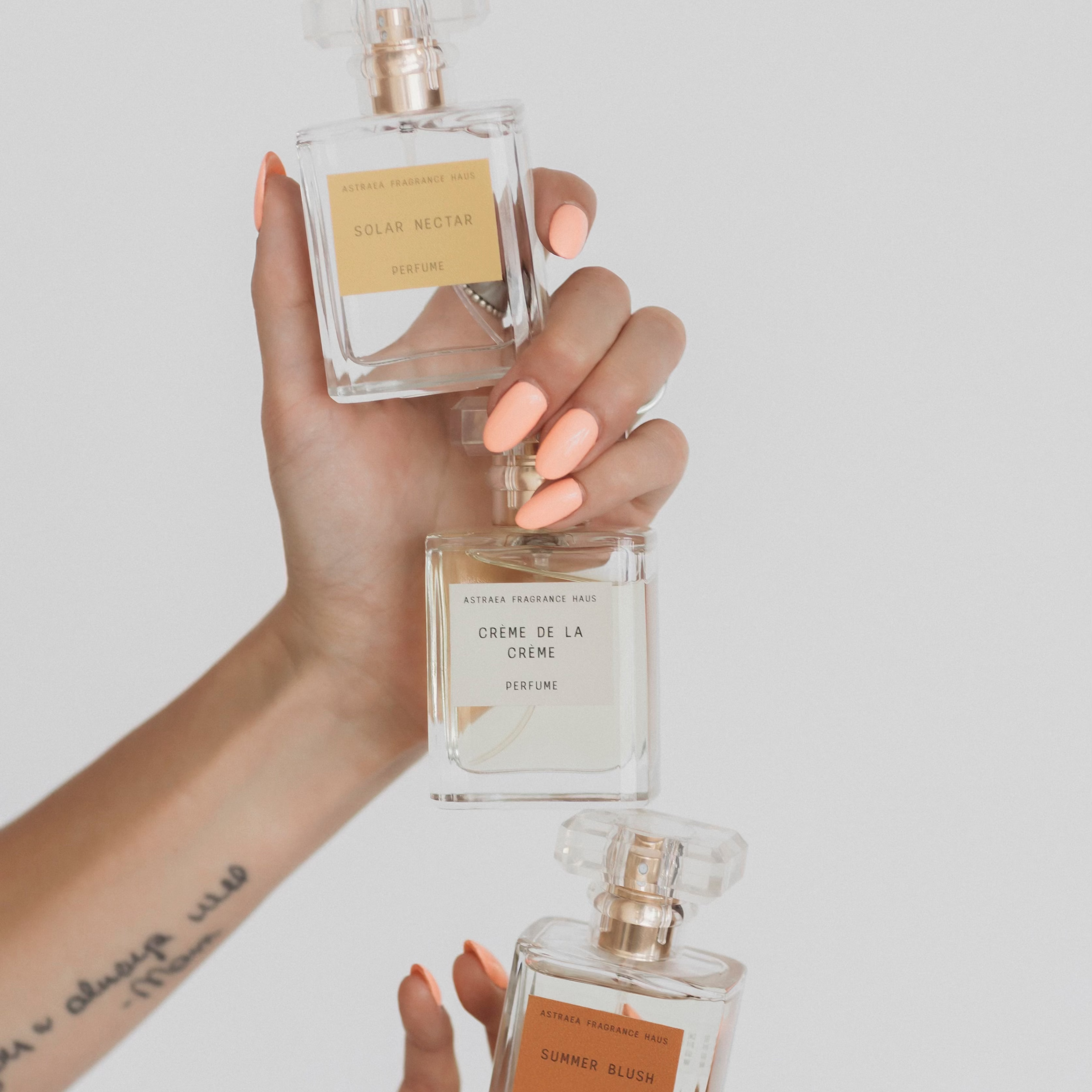 Summer Blush perfume by Astraea Fragrance Haus, elegant glass bottle with blush pink liquid and floral cap design.